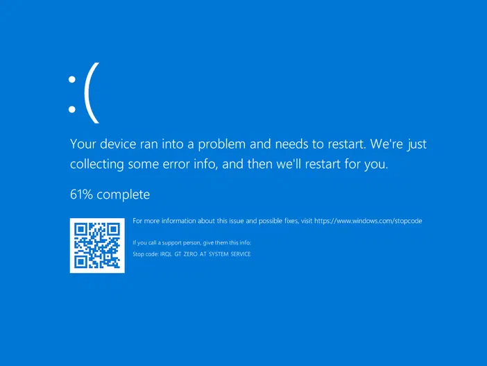 Écran bleu Windows affichant un message d'erreur système avec une icône triste et le code 'IRQL_GT_ZERO_AT_SYSTEM_SERVICE'.